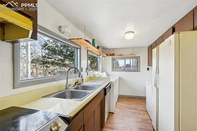 a kitchen that has a sink and a stove