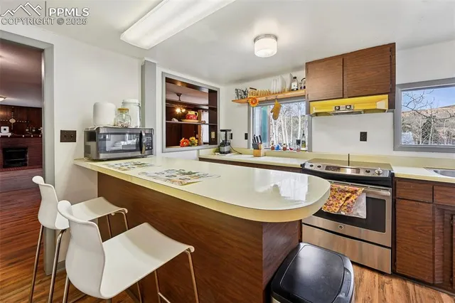 a kitchen with stainless steel appliances granite countertop a sink and stove