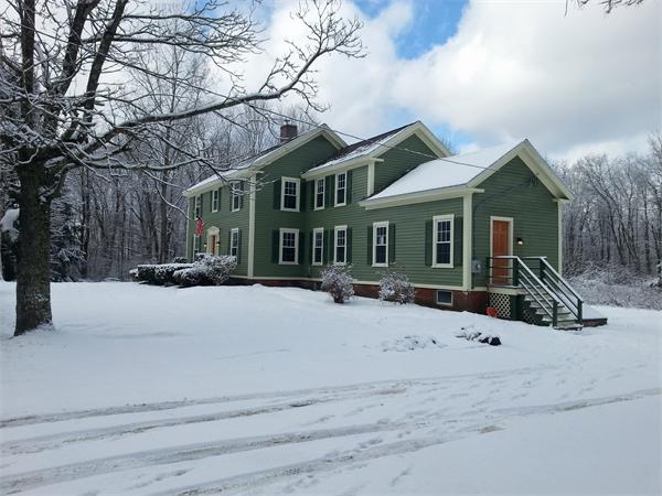 102 Shore Road East Brookfield, MA 01515 - Photo 2 of 13 a front view of house with yard and trees in the background