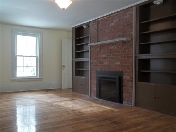 102 Shore Road East Brookfield, MA 01515 - Photo 4 of 13 a view of an empty room with a fireplace and a window