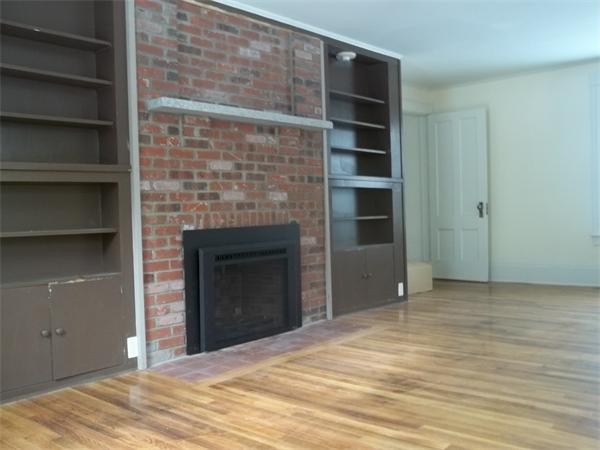 102 Shore Road East Brookfield, MA 01515 - Photo 5 of 13 a view of an empty room with a fireplace and cabinets