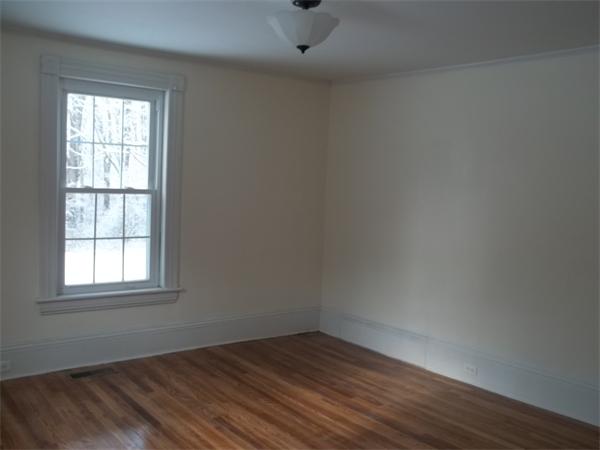 102 Shore Road East Brookfield, MA 01515 - Photo 6 of 13 an empty room with wooden floor and windows