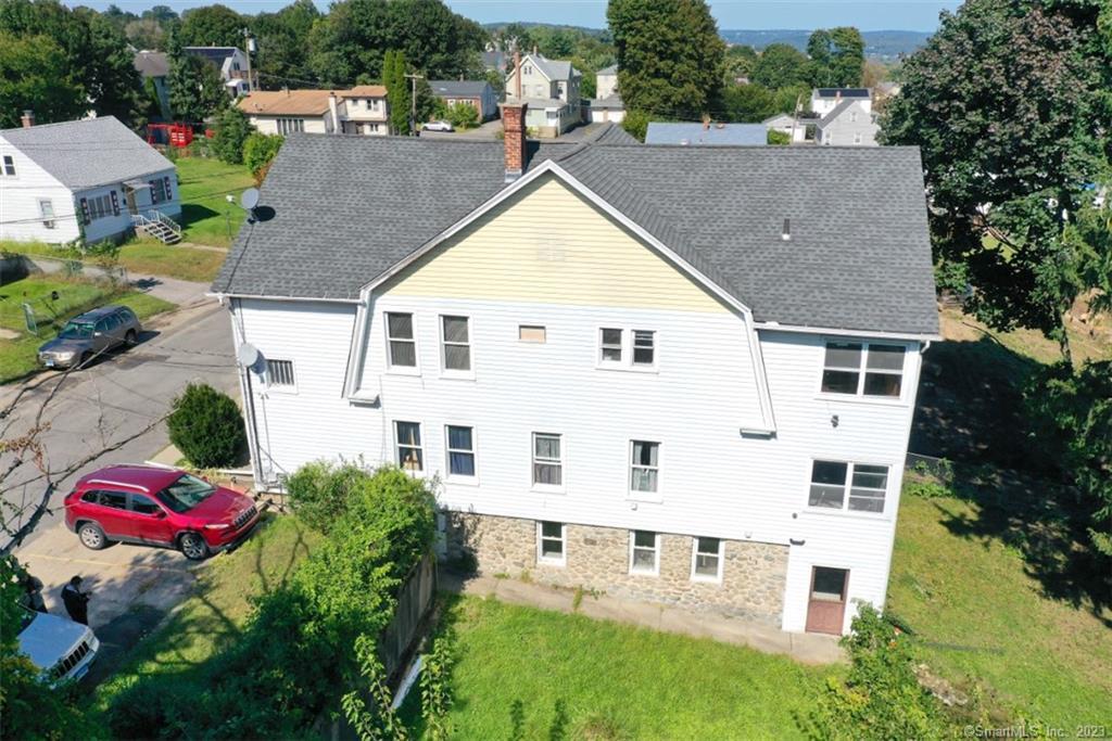 an aerial view of house with yard and trees