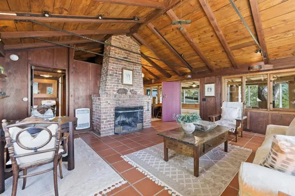 a living room with furniture a fireplace and a table