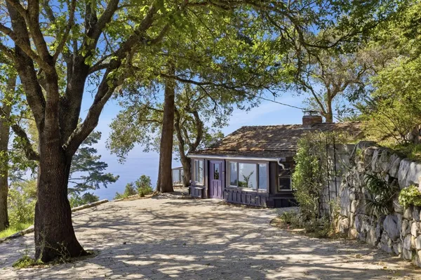 a view of a house with a tree in front
