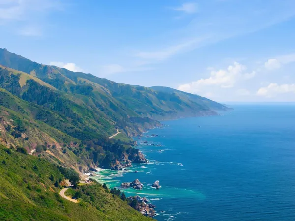 a view of a field with an ocean