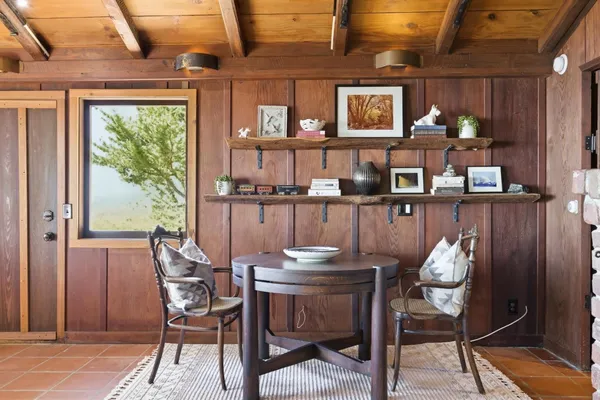 a dining room with furniture and window