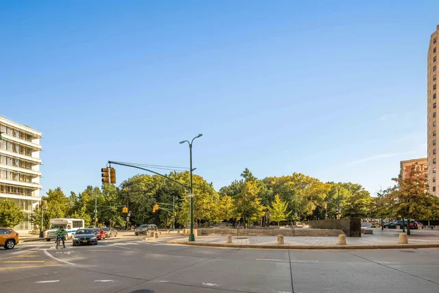 a bathroom with a granite countertop sink mirror vanity and toilet