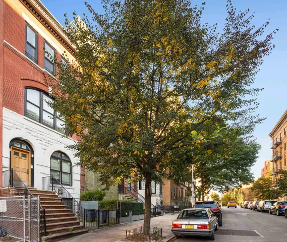 a view of a cars park in front of a building