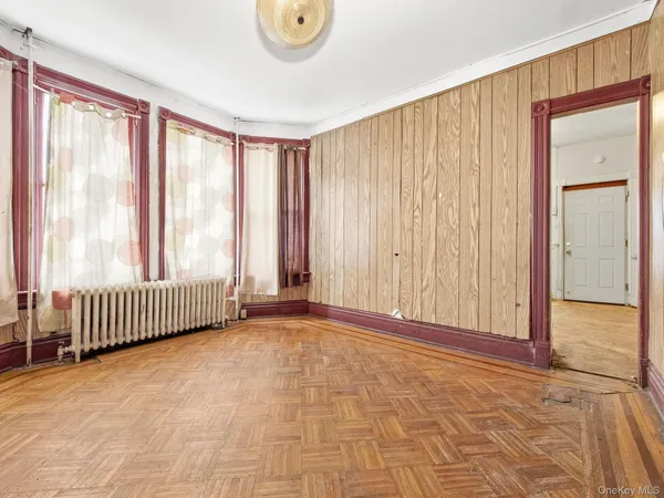 a view of a room with a window and a chandelier