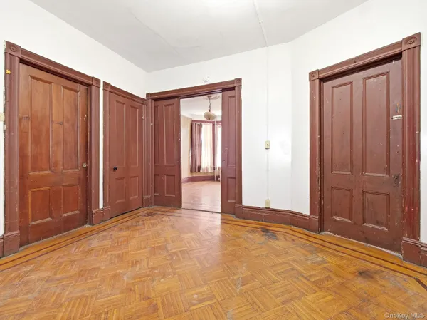 a view of an empty room with window and bathroom
