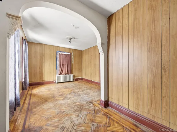 a view of a livingroom with wooden floor and windows