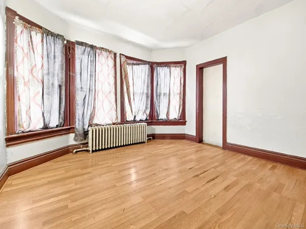 a view of a room with wooden floor and a window