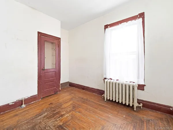 a view of a livingroom with wooden floor and a window