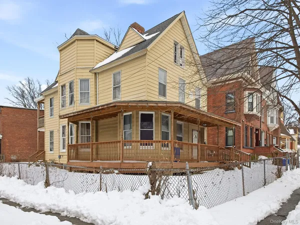 a front view of a house with a garden