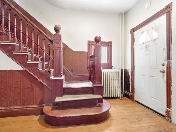 a view of entryway and hall with wooden floor