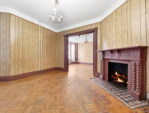 a view of an empty room with fireplace and a window