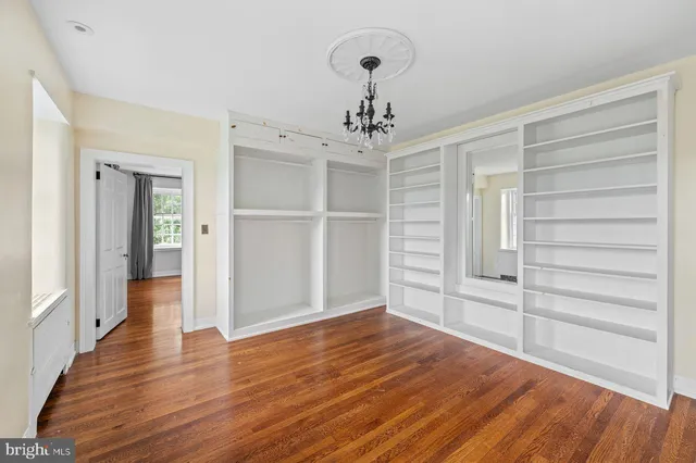 an empty room with windows and a fireplace