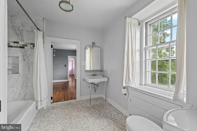 a view of an empty room with a fireplace and a window