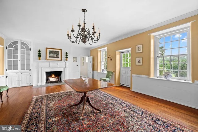 a living room with a fireplace with wooden floor
