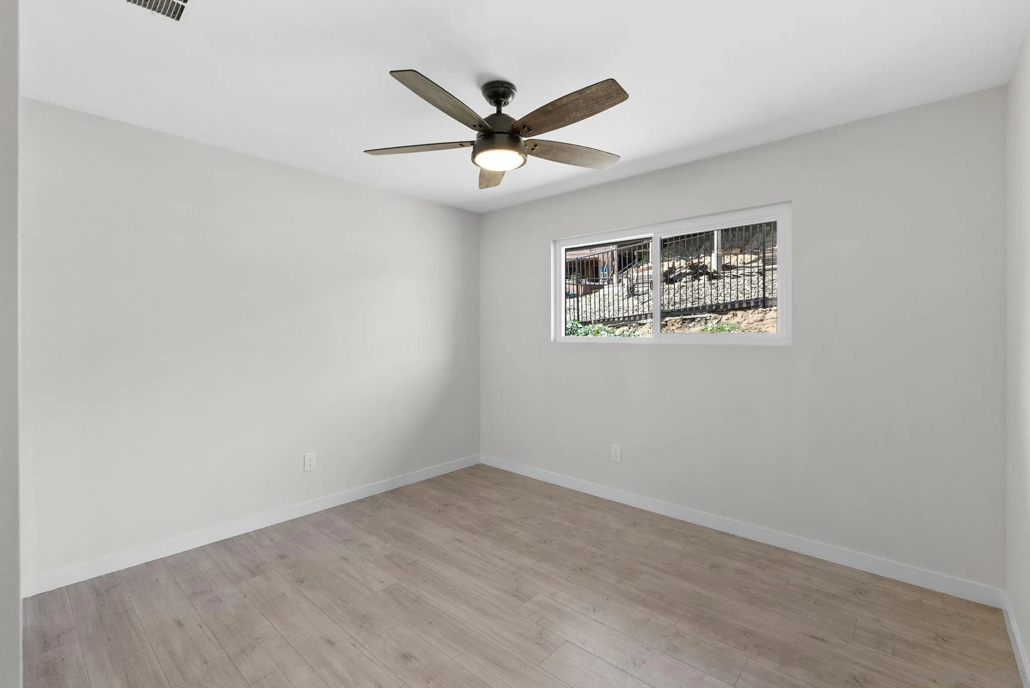 2044 Eula Lane El Cajon, CA 92019 - Photo 32 of 47 an empty room with window and ceiling fan