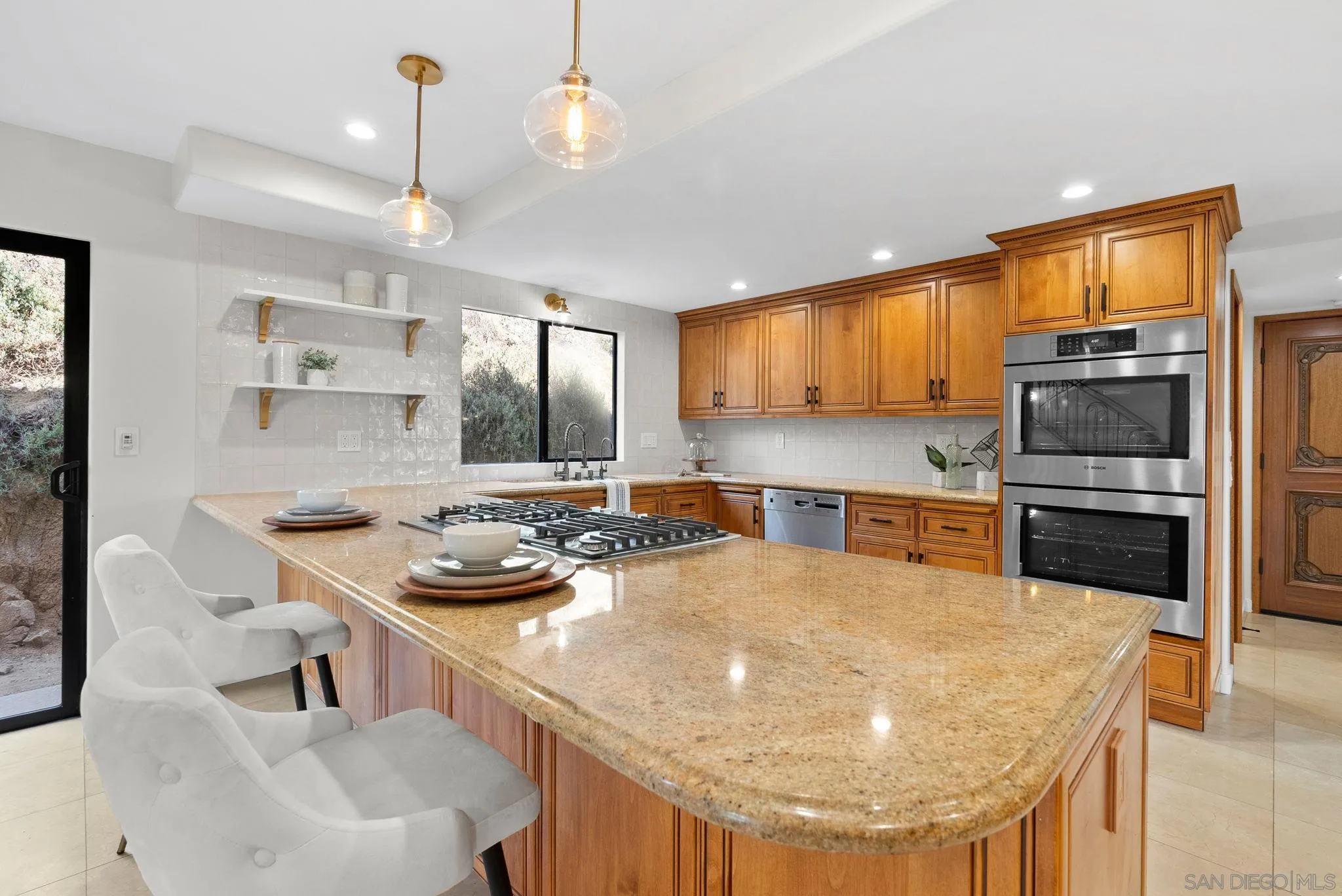 2044 Eula Lane El Cajon, CA 92019 - Photo 10 of 47 a kitchen with a sink a stove and chairs