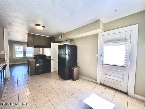 a kitchen with a refrigerator and a sink