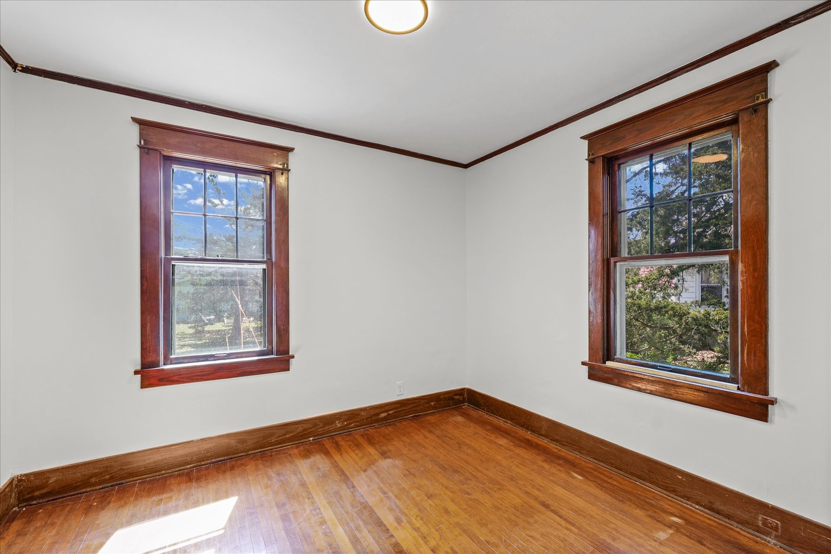 1011 West Vine Street Champaign, IL 61821 - Photo 11 of 19 a view of an empty room with wooden floor and a window