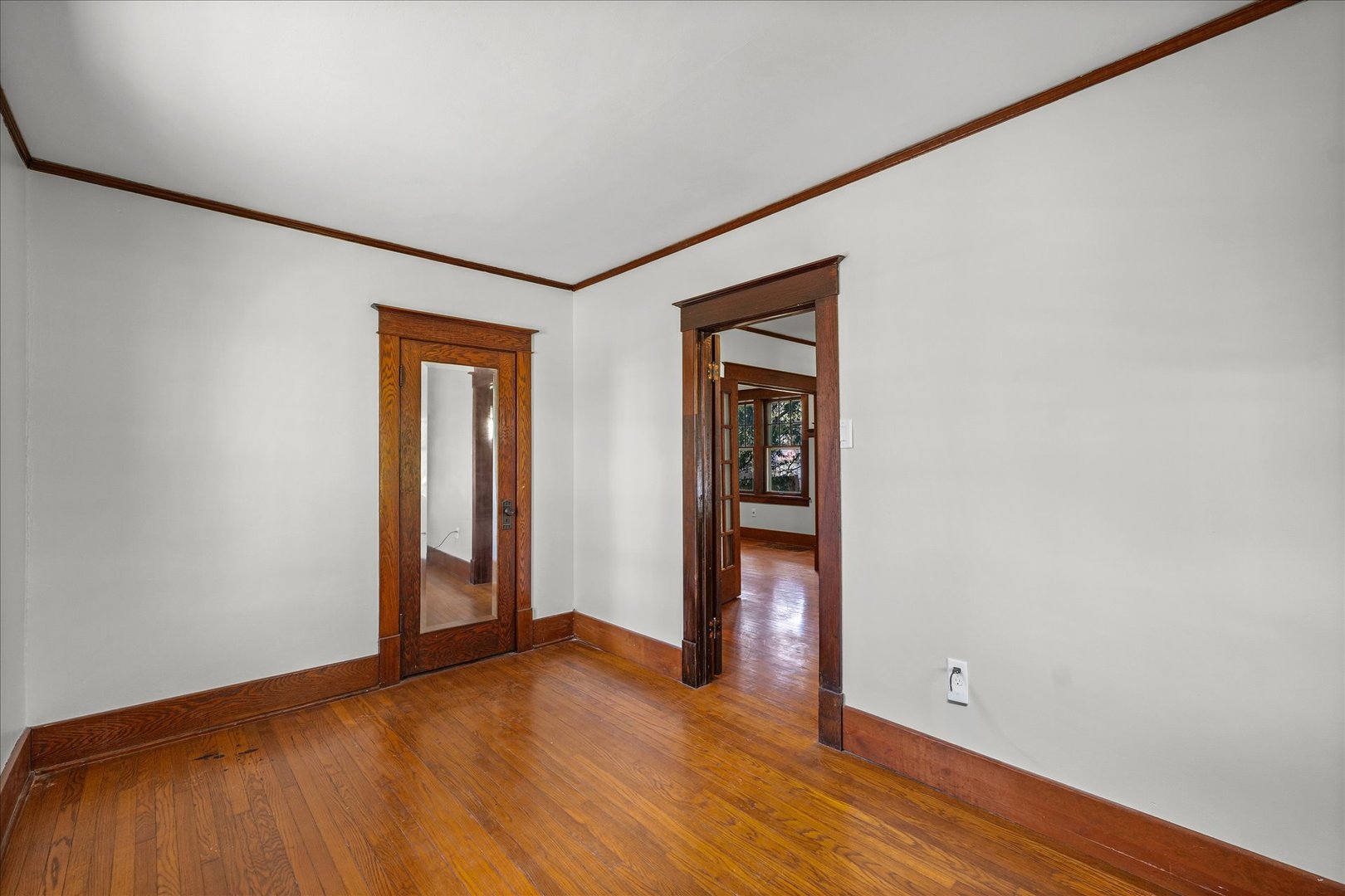 1011 West Vine Street Champaign, IL 61821 - Photo 14 of 19 a view of an empty room with wooden floor and closet