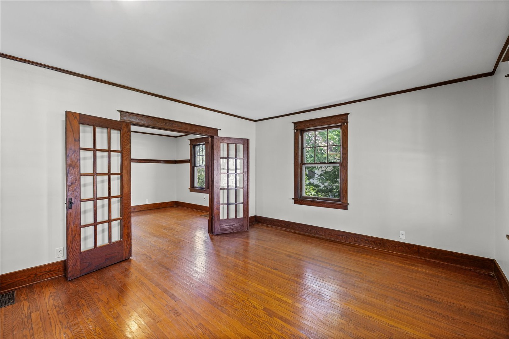 1011 West Vine Street Champaign, IL 61821 - Photo 7 of 19 a view of an empty room with wooden floor and a window