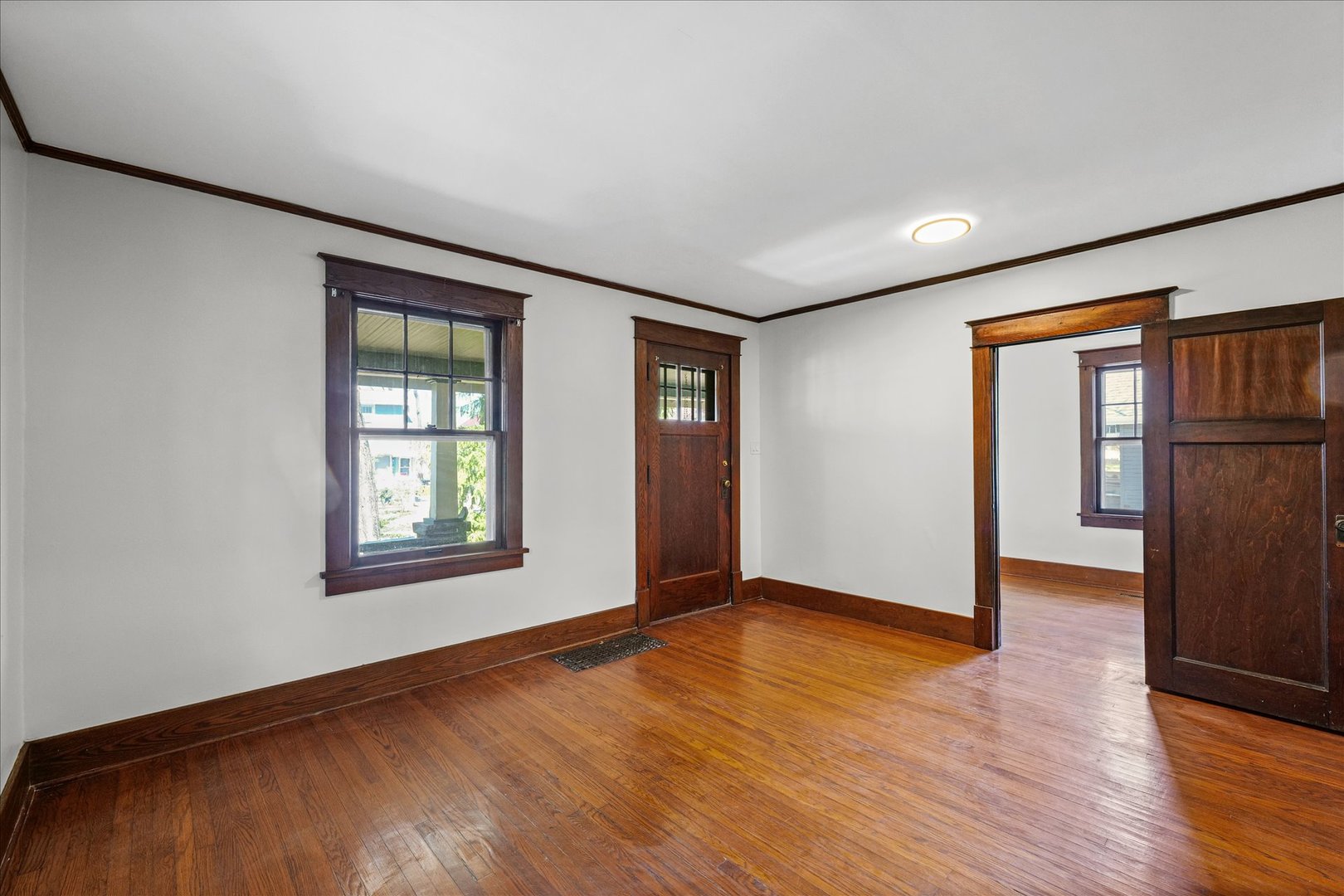 1011 West Vine Street Champaign, IL 61821 - Photo 8 of 19 an empty room with wooden floor and windows