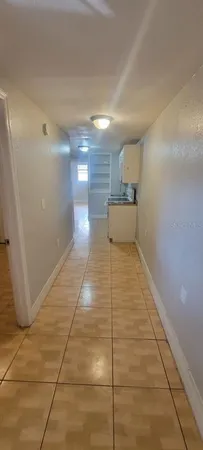 a hallway with a black white checkered floor