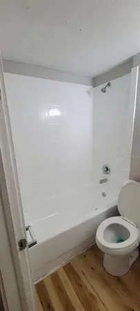 a bathroom with a toilet and a shower