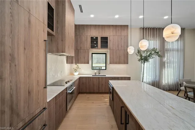 a large kitchen with a sink and dishwasher