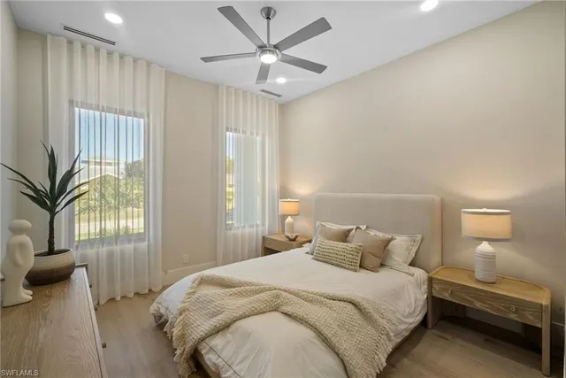 a bedroom with a large bed and a chandelier