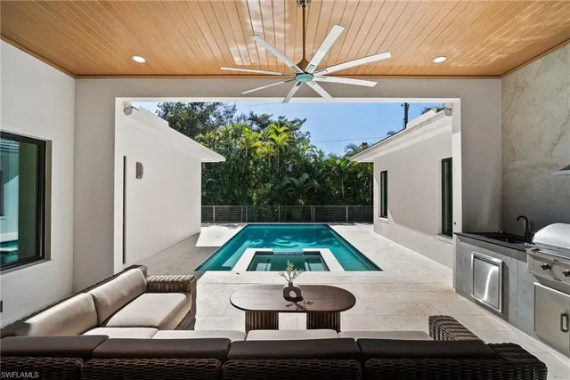 a living room with furniture and a pool table