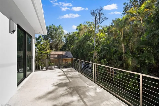 a view of balcony with wooden floor and fence