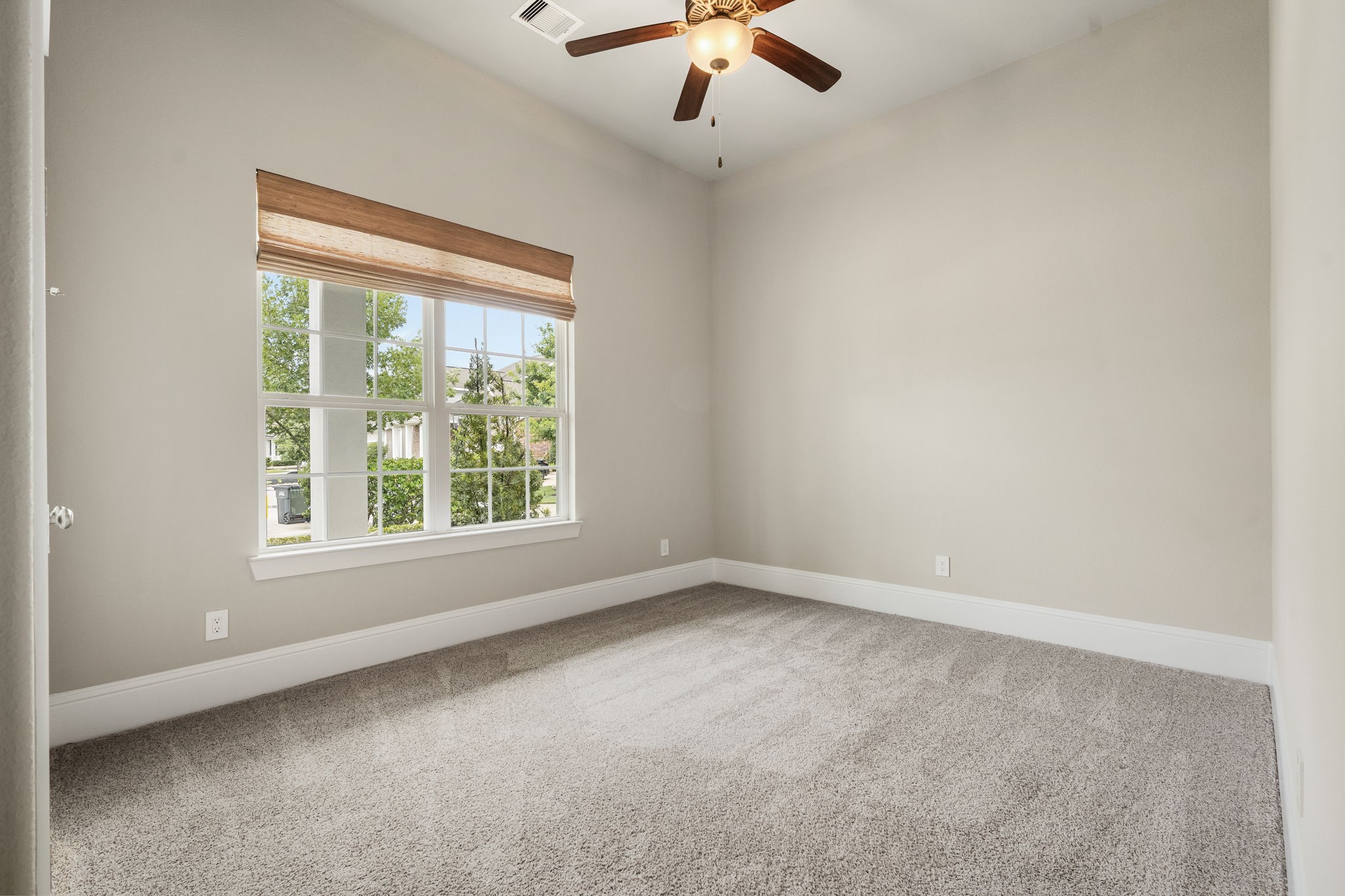 2206 Rope Maker Road Conroe, TX 77384 - Photo 7 of 42 Spacious secondary bedroom with tall ceilings at the front of the home. Ideal for family and guests.