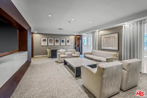 a view of a livingroom with furniture and a flat screen tv