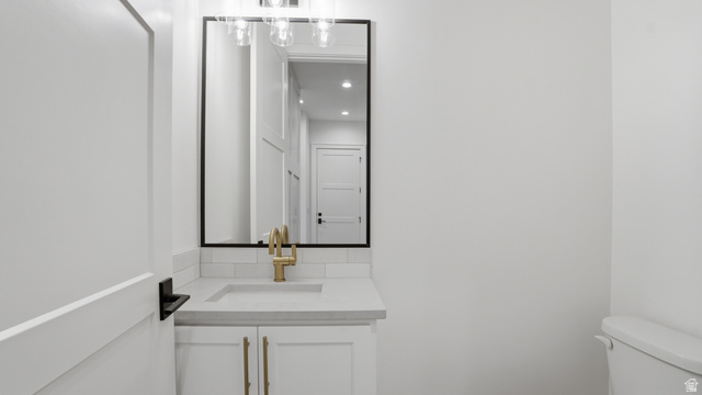 1682 North 1950 W Street, Unit 9 Provo, UT 84604 - Photo 26 of 84 Bathroom vanity featuring a rectangular undermount sink, brass-finish faucet, and coordinating cabinet hardware