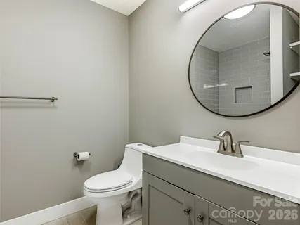 a bathroom with a sink mirror and toilet