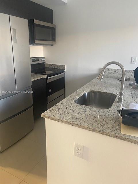 423 East 27th Street, Unit 101 Hialeah, FL 33013 - Photo 1 of 9 a kitchen with kitchen island stainless steel appliances a sink stove and refrigerator