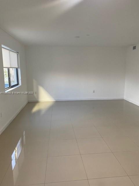 423 East 27th Street, Unit 101 Hialeah, FL 33013 - Photo 4 of 9 a view of an empty room with a window