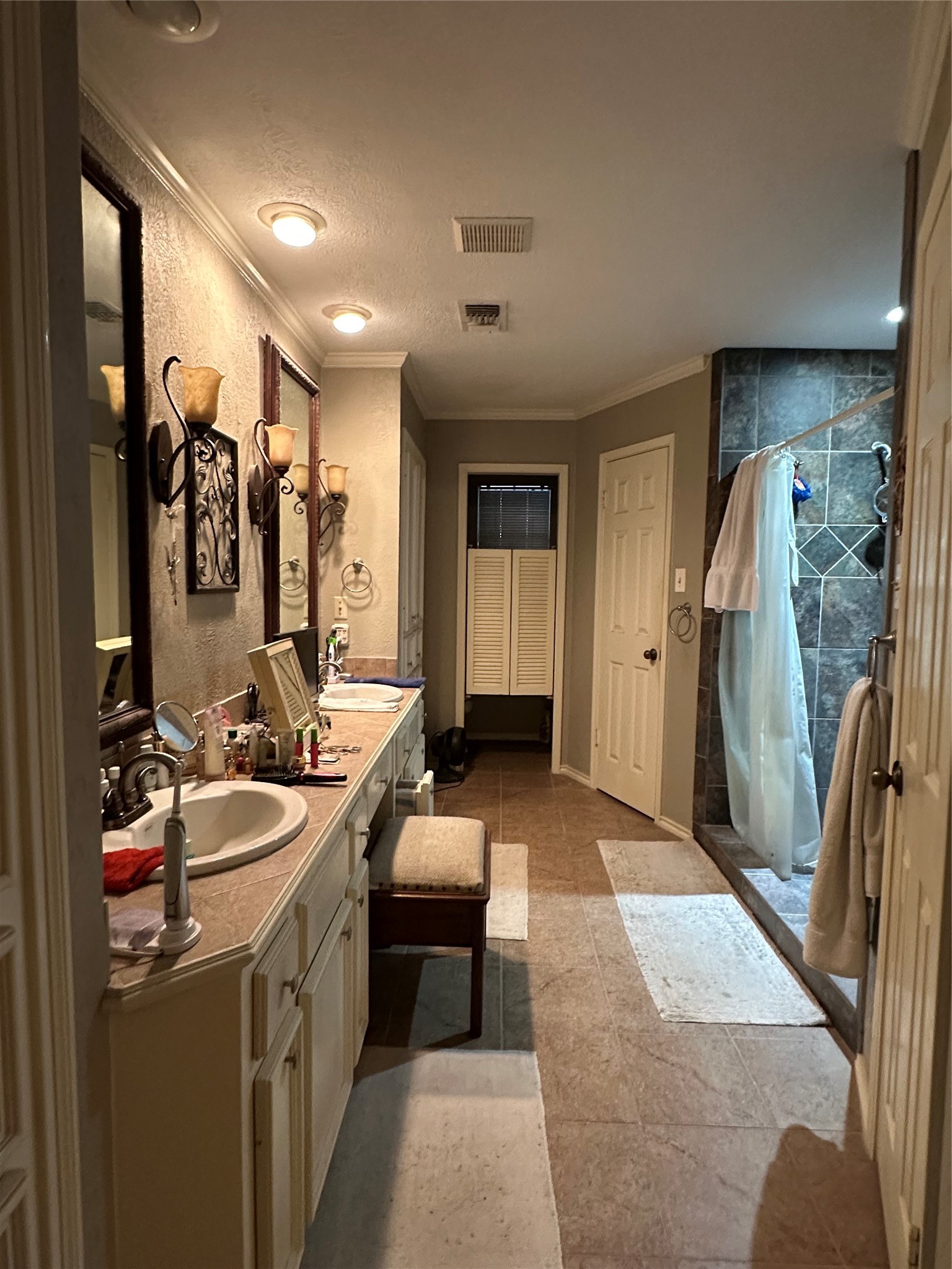 16114 Hexham Drive Spring, TX 77379 - Photo 13 of 18 View of the spacious primary bath with dual sinks, vanity, his-and-hers closets and tiled shower.