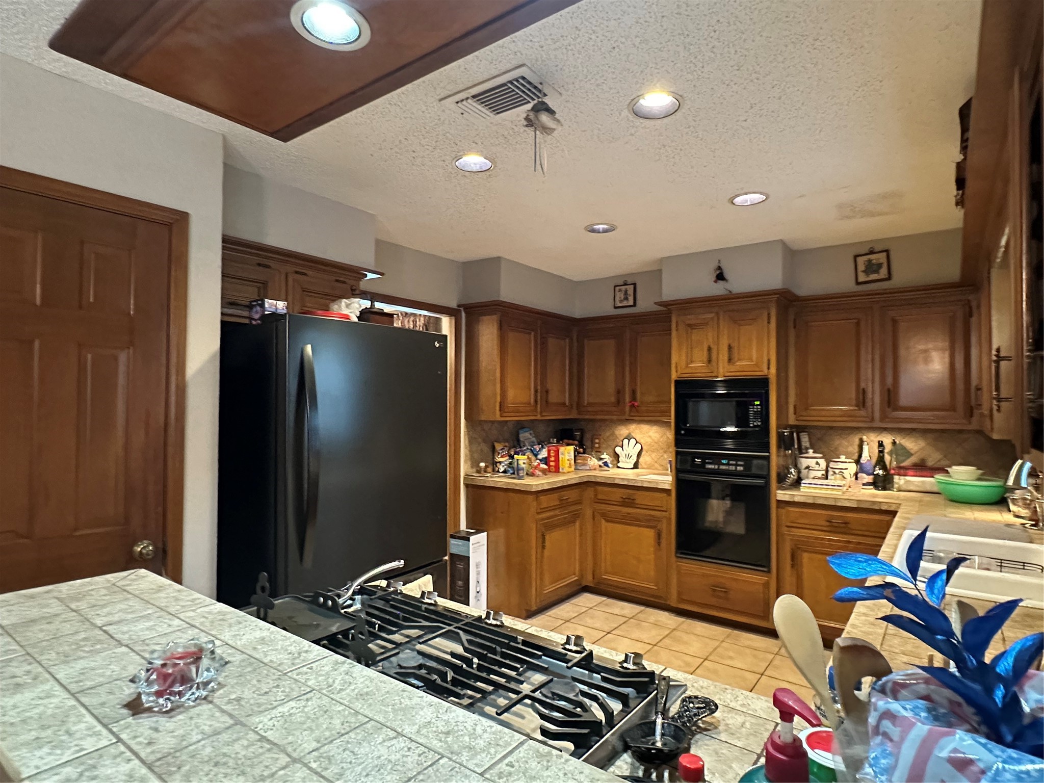 16114 Hexham Drive Spring, TX 77379 - Photo 9 of 18 Another view of the kitchen with a gas cook top and abundant cabinets for storage.
