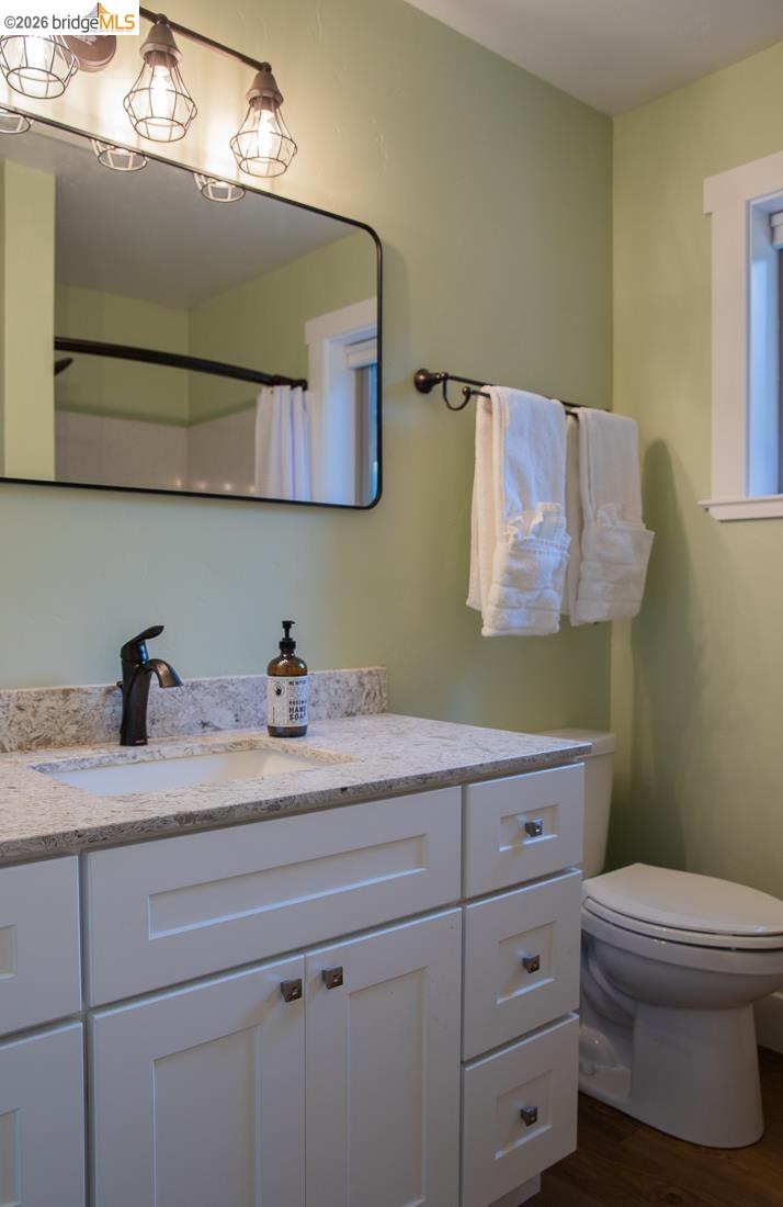 18399 Lime Kiln Road Sonora, CA 95370 - Photo 27 of 36 Bathroom featuring a white vanity with shaker-style cabinetry, a granite-finish countertop, and an undermount sink with a matte black faucet