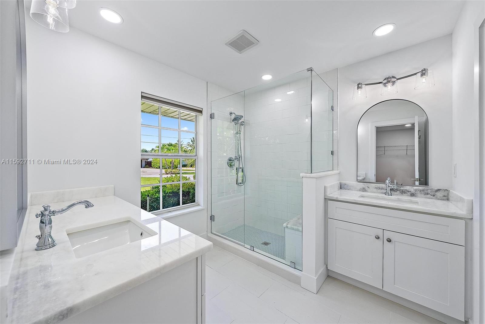 8547 Southeast Merritt Way Jupiter, FL 33458 - Photo 11 of 27 a bathroom with a double vanity sink mirror and shower