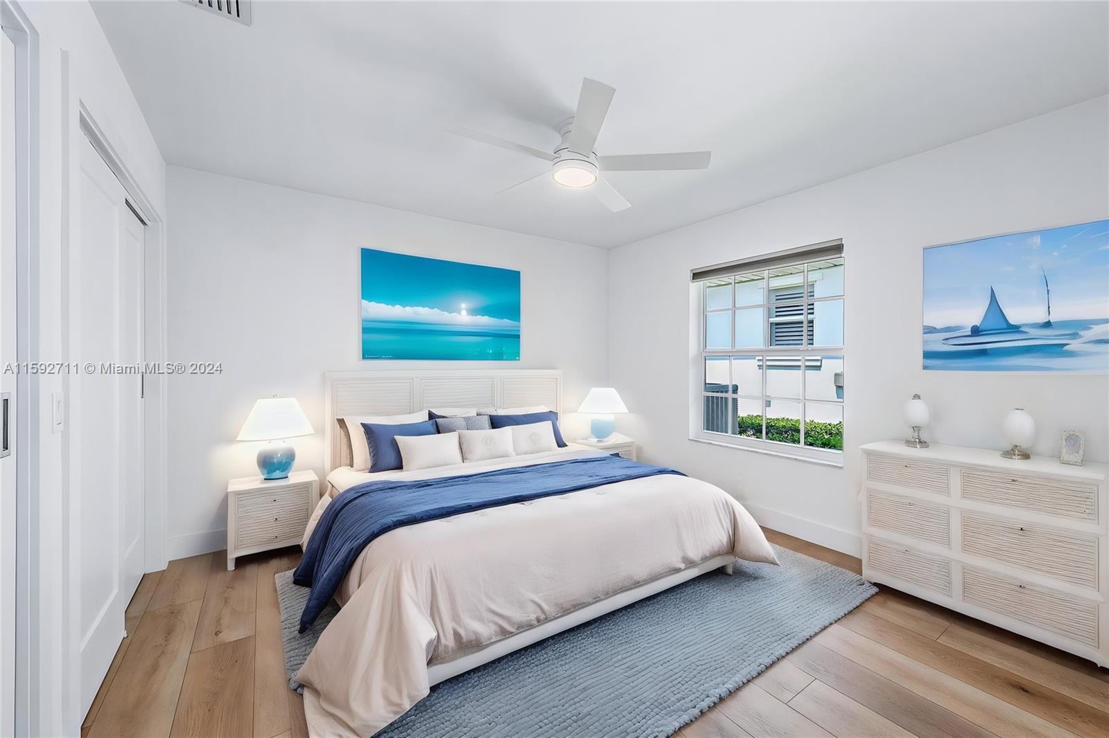 8547 Southeast Merritt Way Jupiter, FL 33458 - Photo 13 of 27 a bedroom with a bed and a dresser