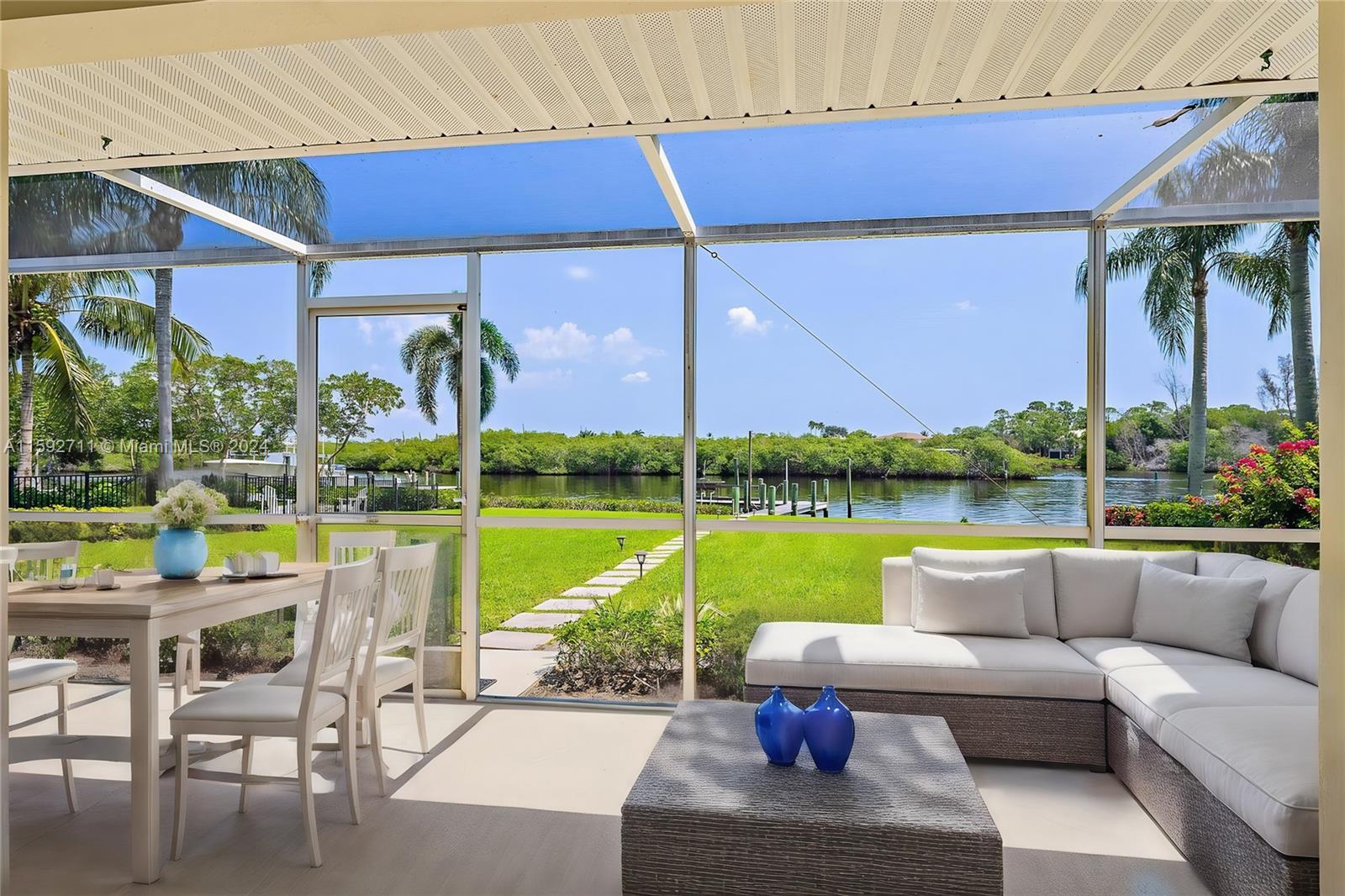 8547 Southeast Merritt Way Jupiter, FL 33458 - Photo 16 of 27 a view of a patio with couches and pool