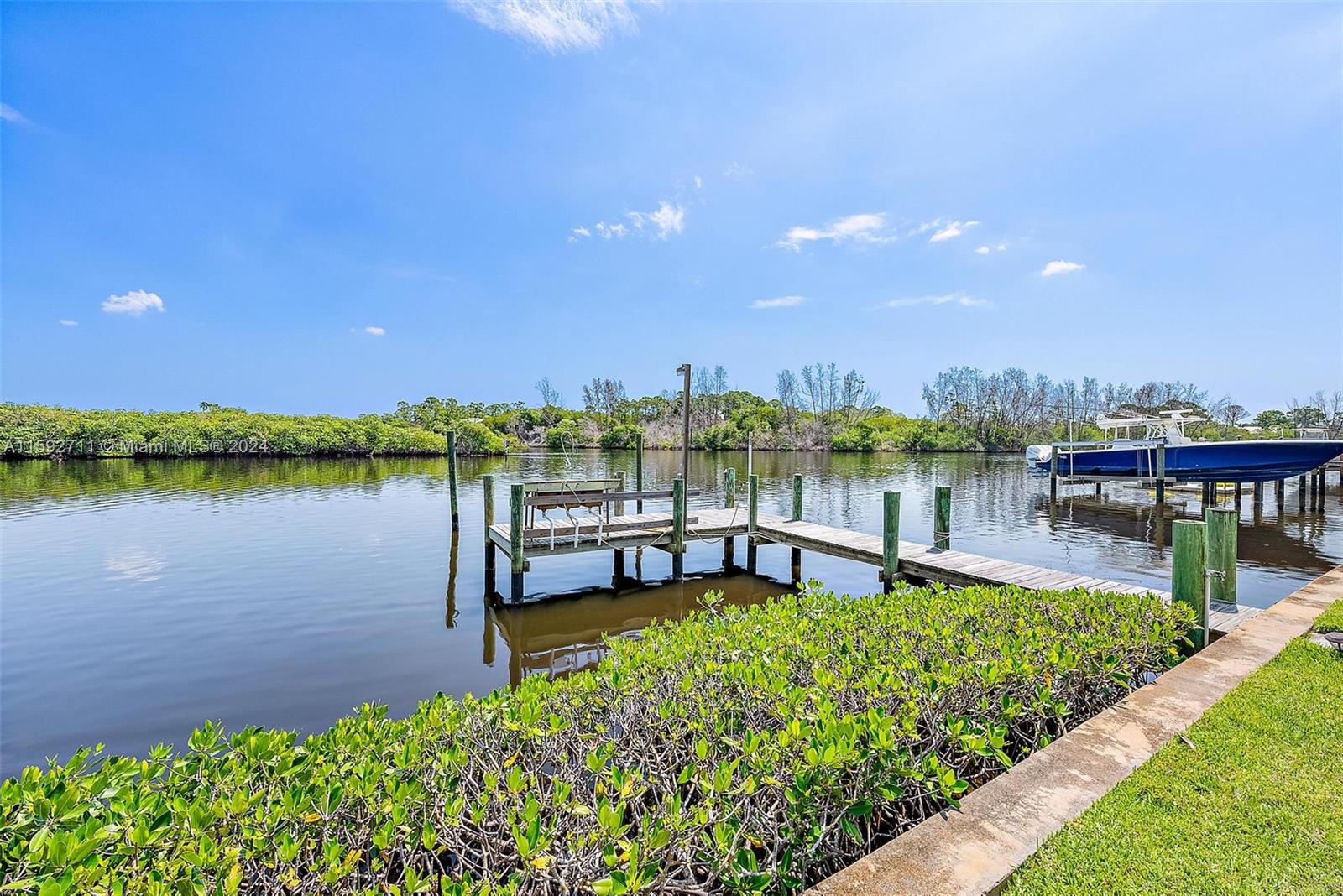8547 Southeast Merritt Way Jupiter, FL 33458 - Photo 21 of 27 a view of a lake with houses in the background